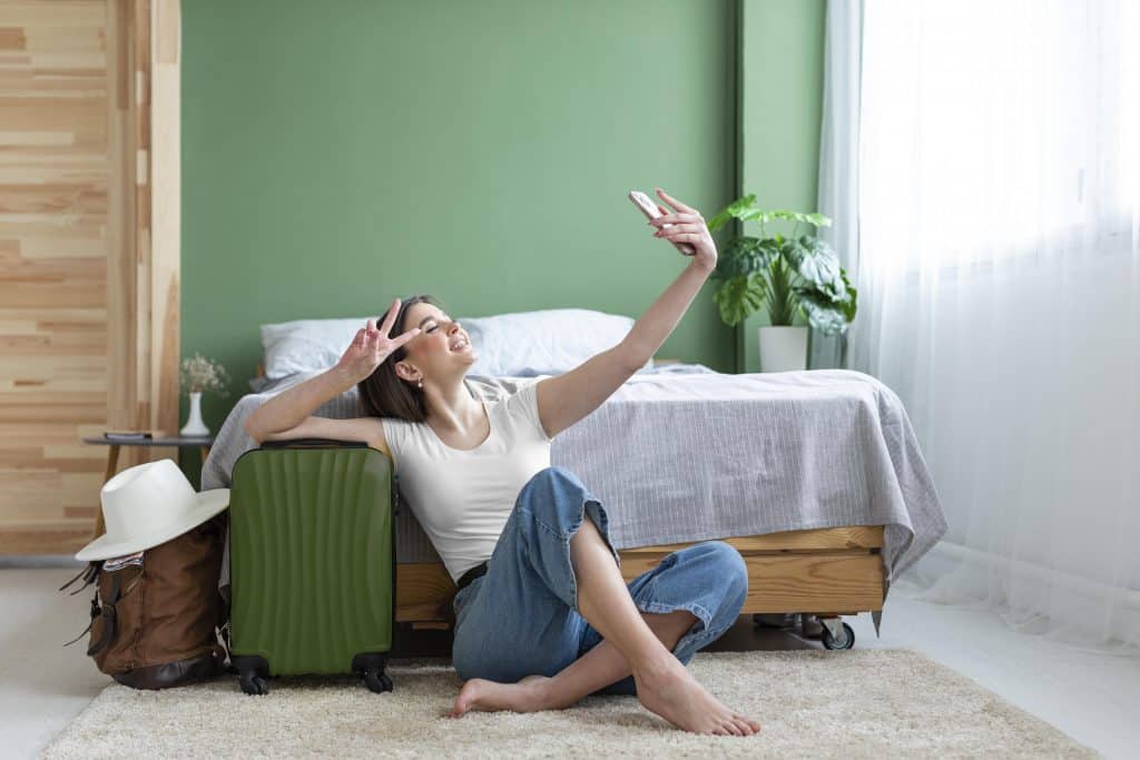 full shot woman taking selfie with luggage